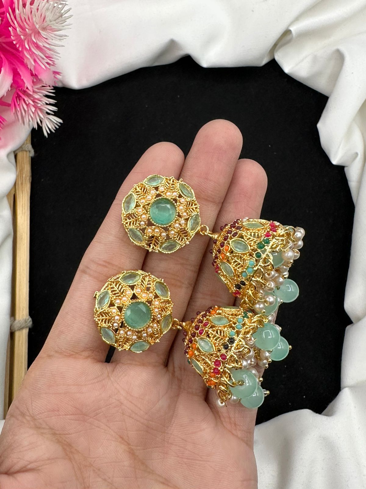 Elevate your style with our graceful Manjoos Jhumki, adorned with moti bandai & sparkling zircon work.